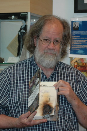 Photo of Greg Ketter holding a book