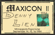 Denny Lien's Maxicon 2 badge.  Denny's name is handwritten, and it has one holographic sticker.