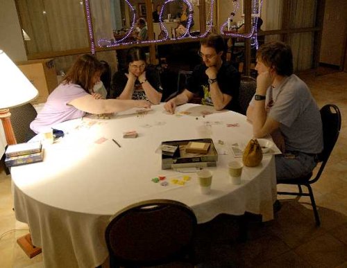 4 people playing a game in the bar