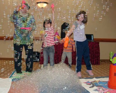 Photo by Dave Romm: Richard, some kids, and a huge pile of bubbles at Minicon 42