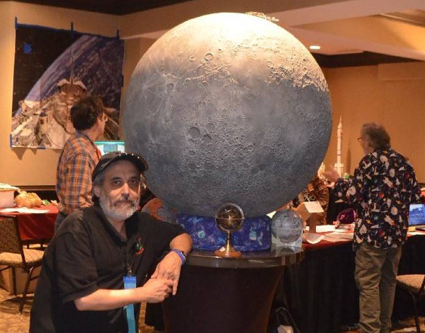 Science room head Ben Huset in front of bas relief Moon